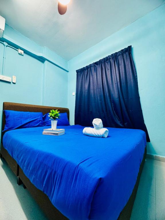 a blue bedroom with a blue bed with blue sheets at 3br 8 pax budget Malaysian guest only family stay in penang in Gelugor