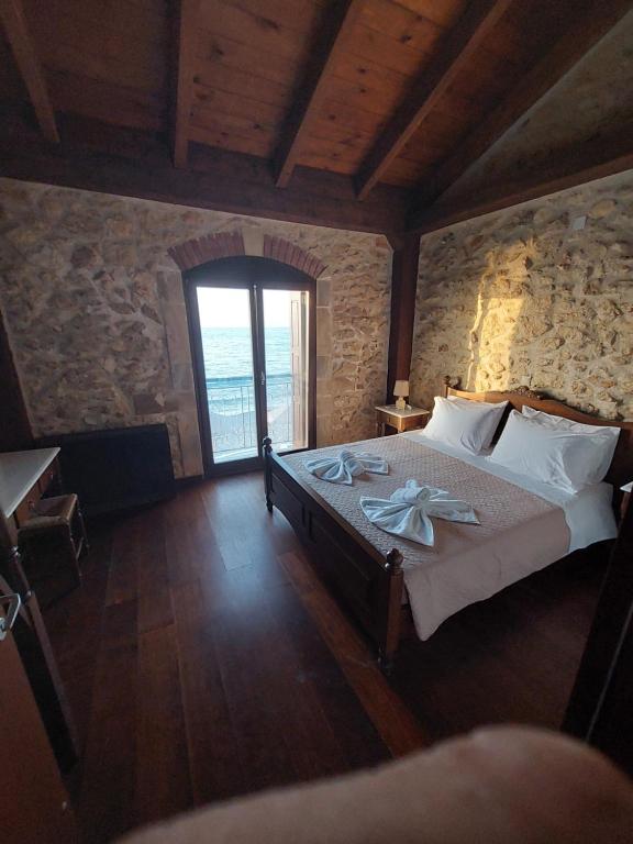 a bedroom with a bed with towels on it at Volakas Beachfront Suites in Rethymno