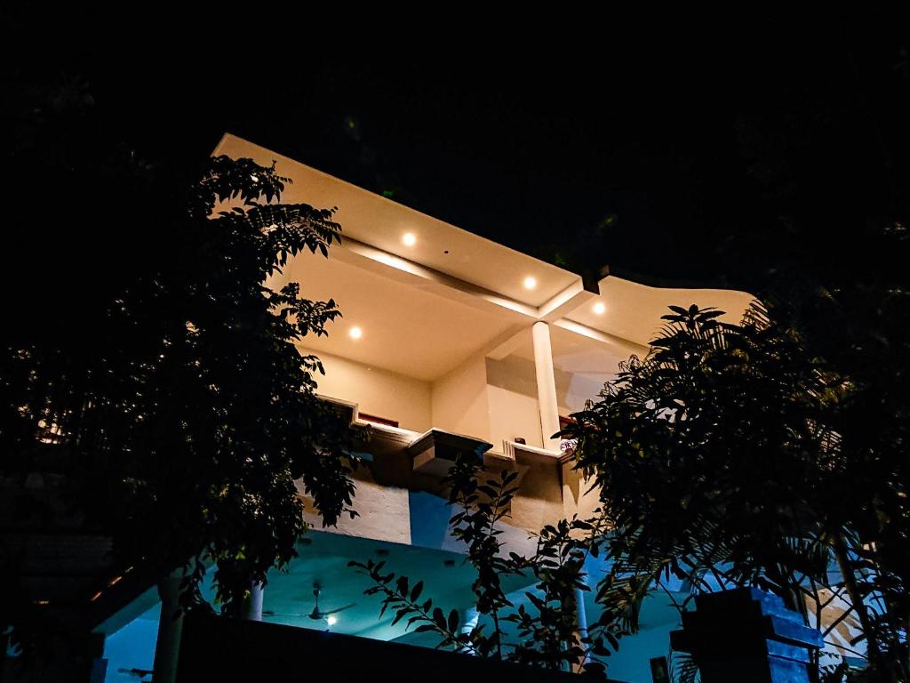 a building with lights on the side of it at night at Angel White in Unawatuna in Unawatuna