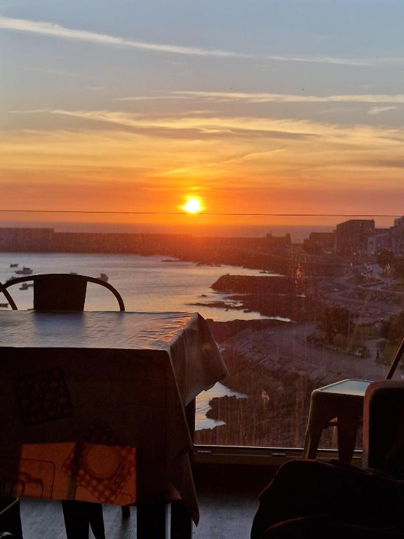 a sunset from a table with a view of a river at Porto A Guarda in A Guarda