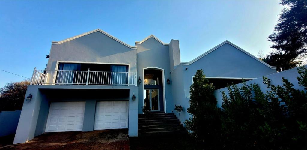 a white house with a garage at Belle Vie Boutique Guesthouse in Pretoria