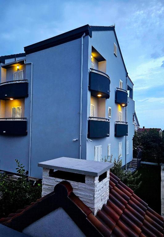 a large white building with a balcony on it at Perla No1 in Kaštela