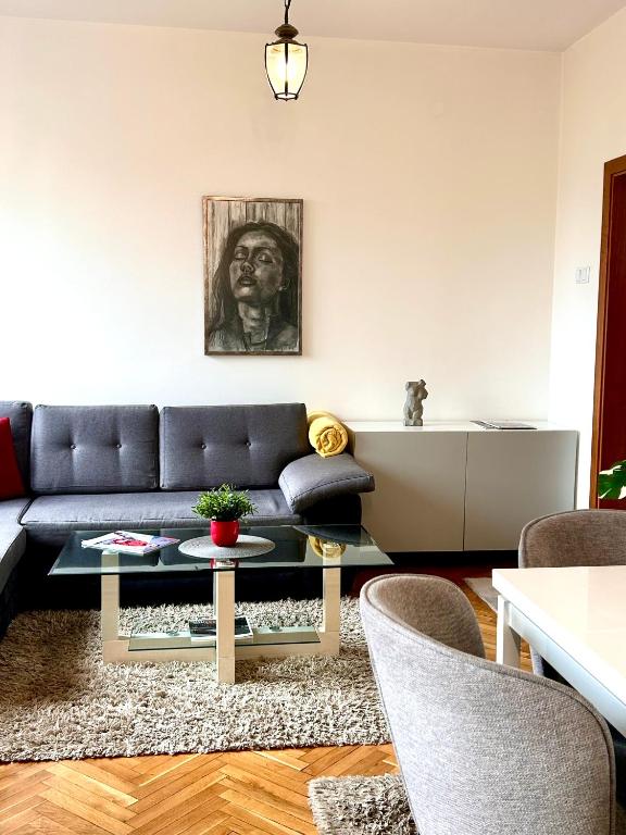 a living room with a couch and a table at Apartment DOLCE CASA in Varna City
