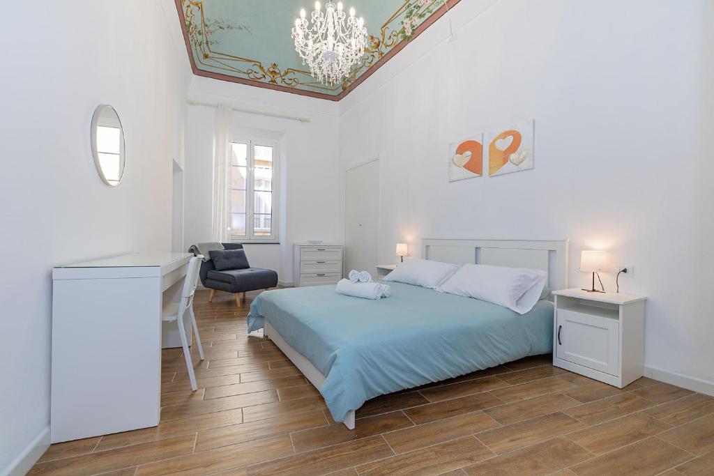 a bedroom with a bed and a desk and a chair at San Biagio apartment in Finale Ligure