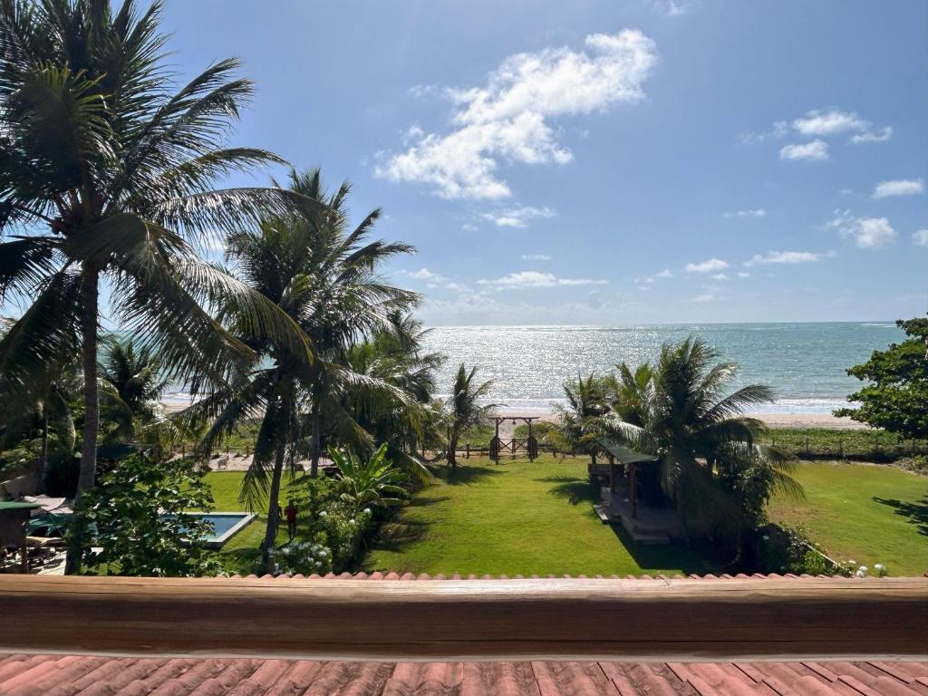 a view of the beach from the balcony of a resort at Casa Turmalina in Japaratinga
