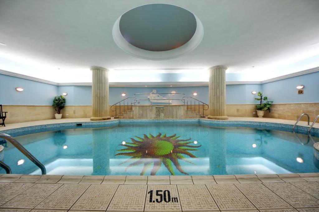 a large swimming pool in a hotel room at Vivaldi Hotel in St. Julianʼs