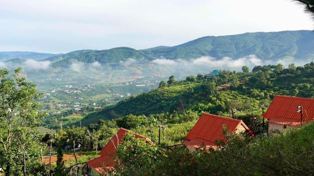 a view of a valley with mountains and houses at Dreamers Garden Farmstay in Hoat