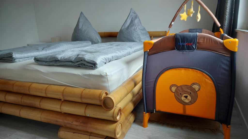 a childs bed with a teddy bear on it at Idyllische Ferienwohnung nahe Triberg in ruhiger Lage mit Balkon und Parkplatz in Sankt Georgen im Schwarzwald