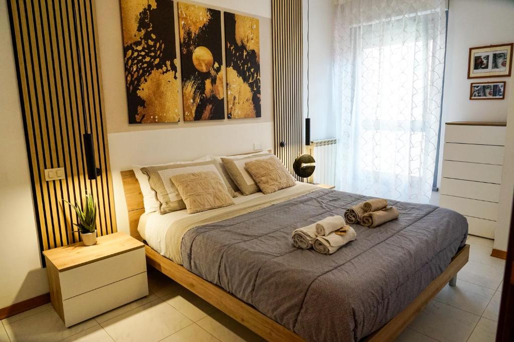 a bedroom with a bed with two towels on it at House 105 Suite Apartment in Perugia