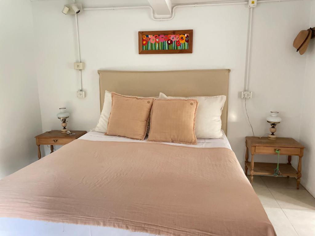 a bedroom with a large bed with two tables at Casa taller in Tigre
