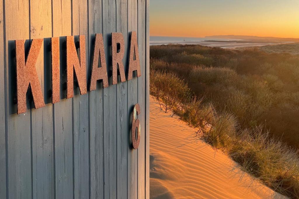 a sign that says nima on the side of a beach at KINARA in CAMBER in Camber