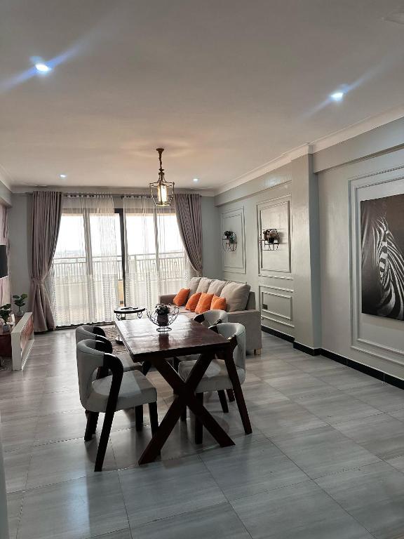 a living room with a table and a couch at CasaComfy Bukoto in Kampala