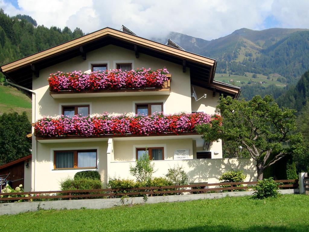 a house with flowers on the side of it at Appartement Sylvester in Matrei in Osttirol