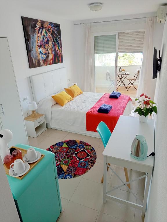 a small room with a bed and a table and a table sidx sidx at Habitación Estepona Rainbow in Estepona