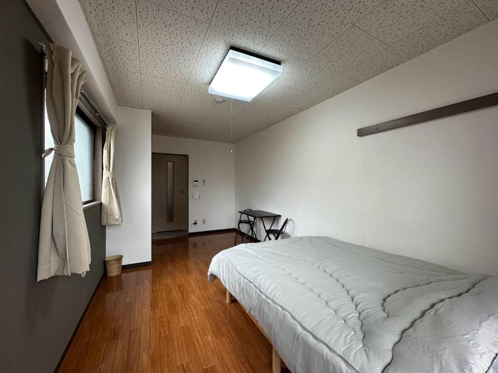 Postel nebo postele na pokoji v ubytování ハレノヒハクシマ