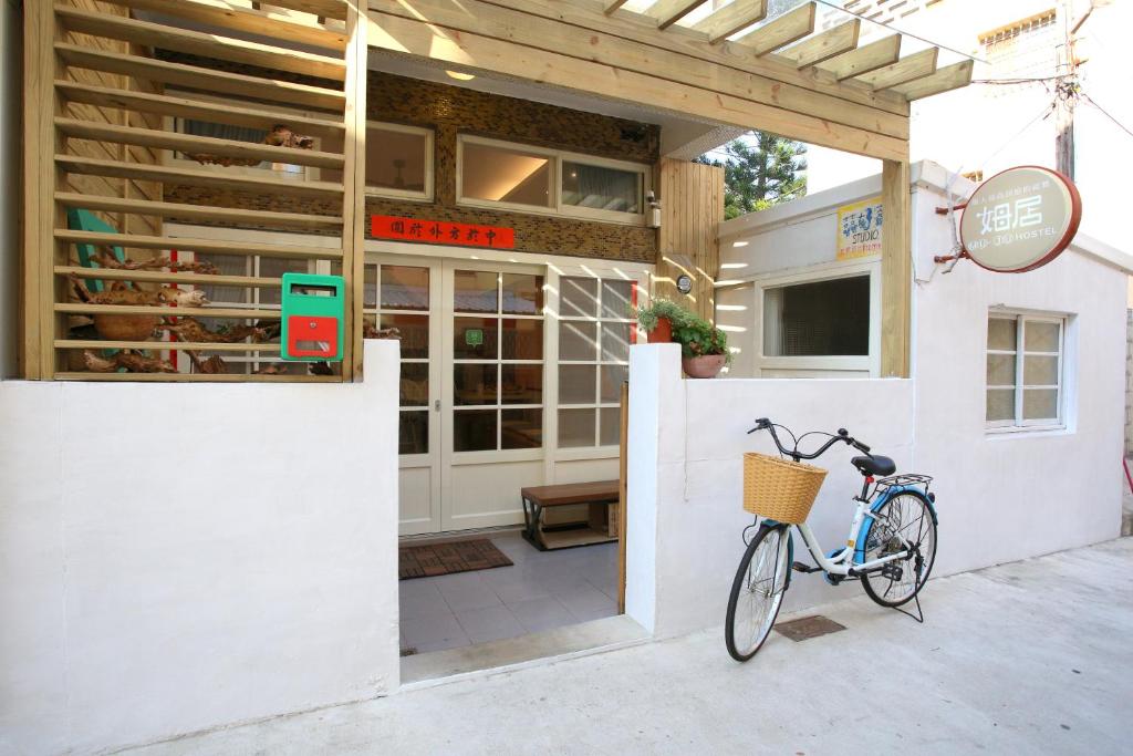 a bike parked outside of a building with a bakery at Mu Ju B&B in Magong