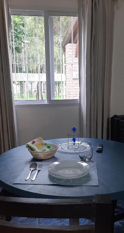 a table with a plate and a bowl on it at Puñadito de Descanso B in Salta