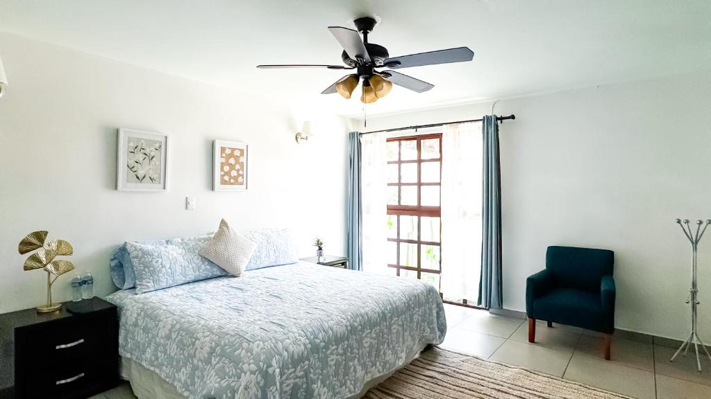 a bedroom with a bed and a ceiling fan at Casa Boutique Sabu in Oaxaca City