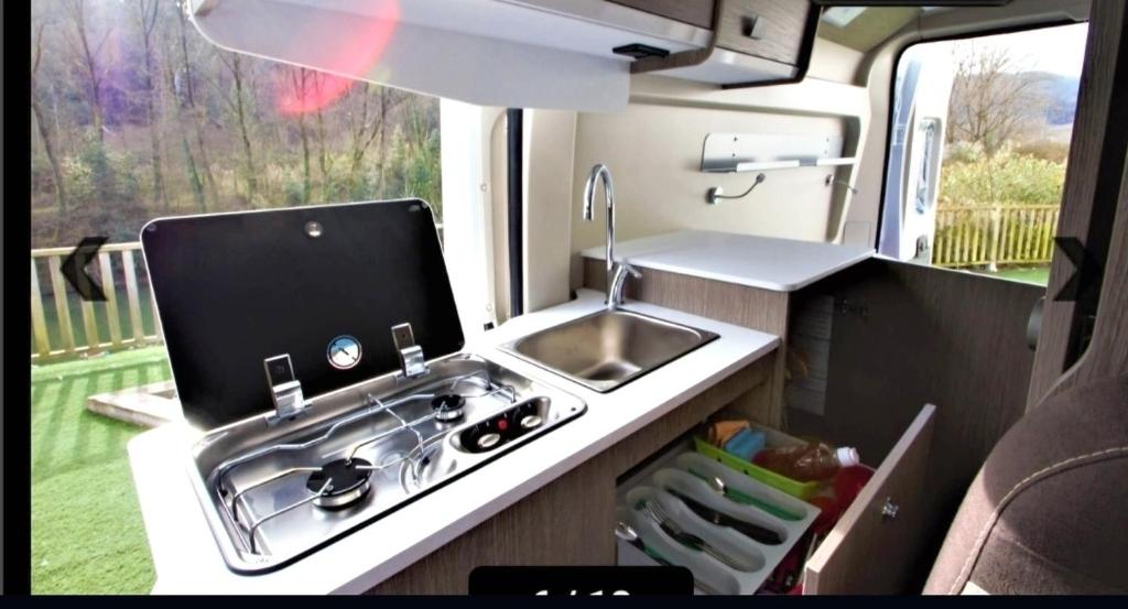 a kitchen in an rv with a sink and a sink at Camper La Palma in Santa Cruz de la Palma