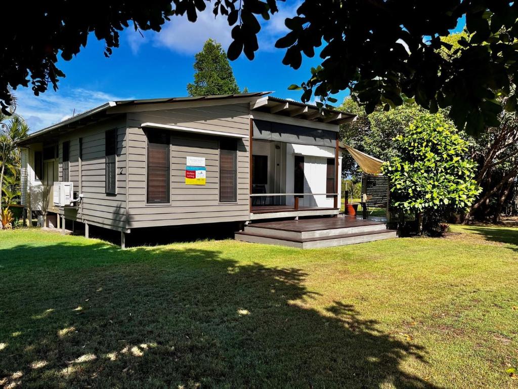 a small house with a porch and a yard at Rainbow North - Rainbow Beach in Rainbow Beach