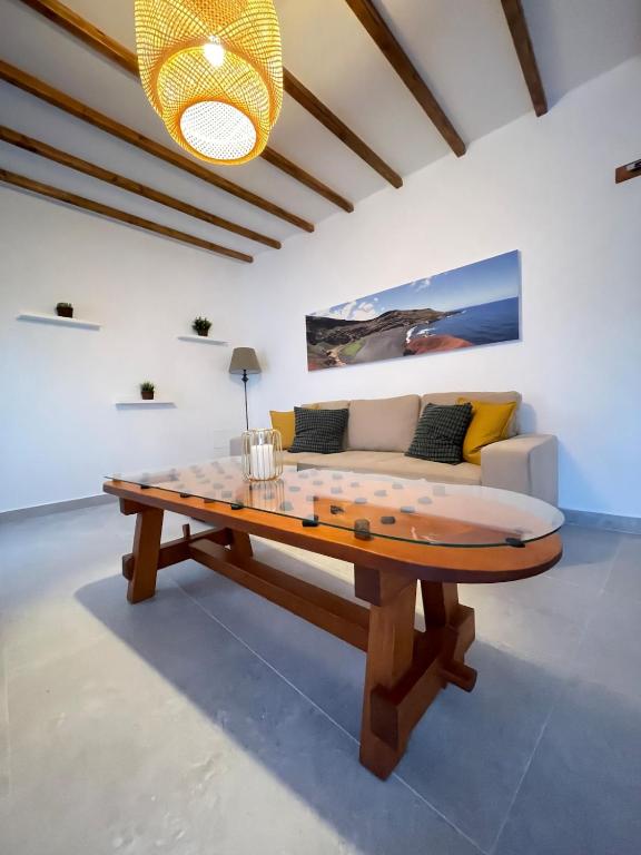 a living room with a table and a couch at Casa Tere in Teguise