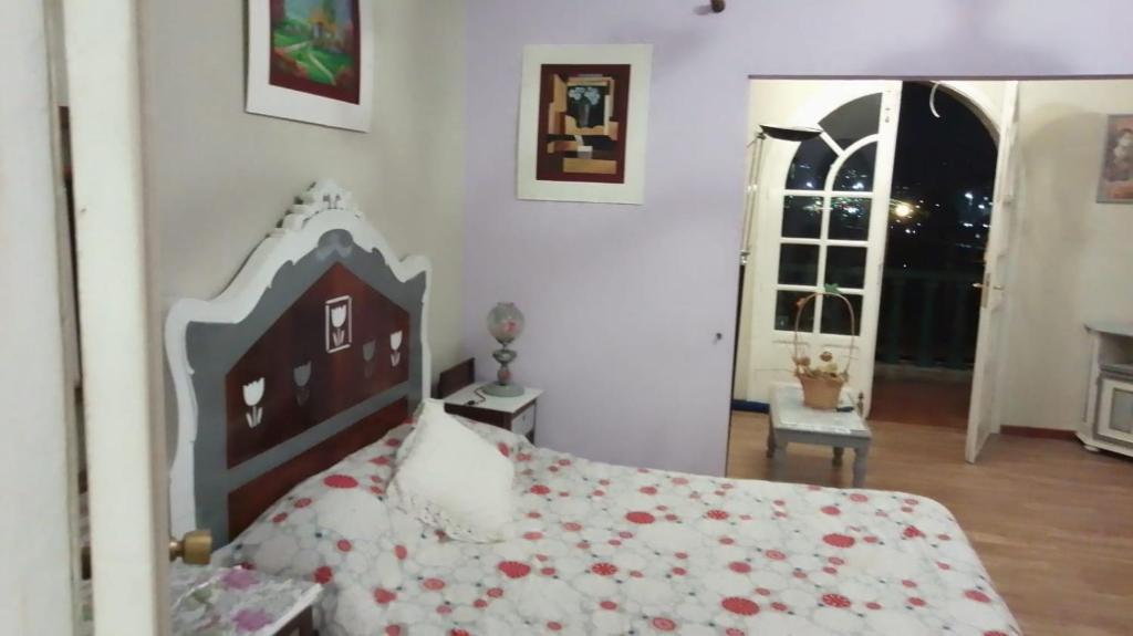 a bedroom with a bed and a room with a window at A casiña de Morais in Pontevedra