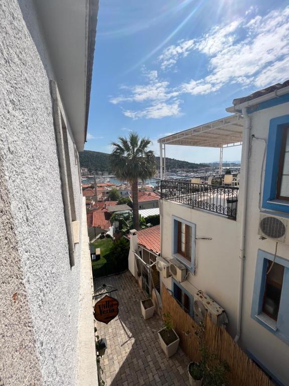 a view from the balcony of a building with a palm tree at Villa Veria in Çeşme