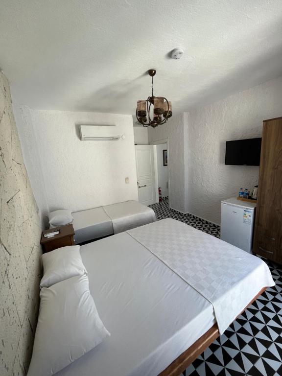 a bedroom with a large white bed in a room at Villa Veria in Çeşme