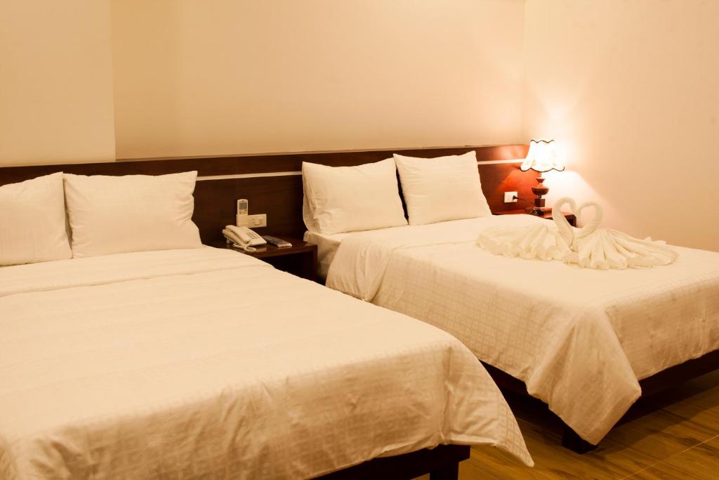 Postel nebo postele na pokoji v ubytování Phuong Linh Hotel
