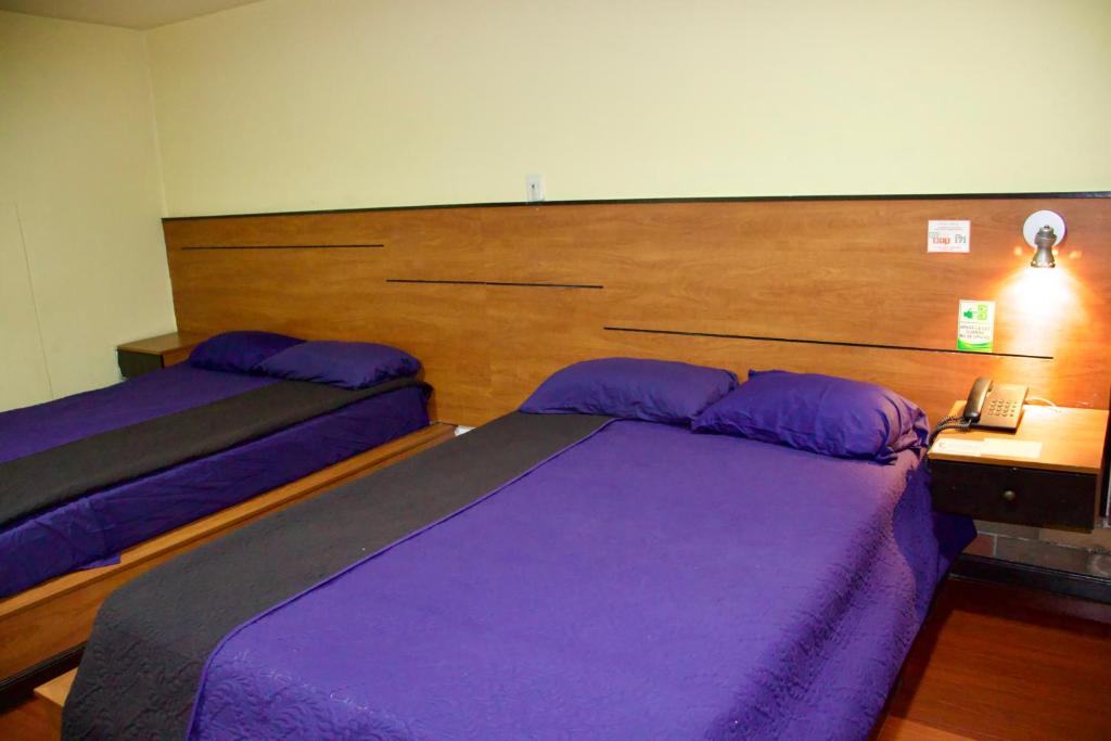 Postel nebo postele na pokoji v ubytování Hostal History