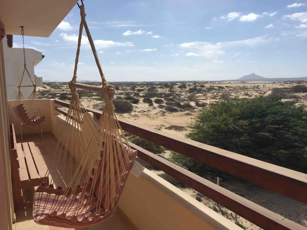 a hammock on a balcony with a view of the desert at Beachapartment fully serviced in Sal Rei