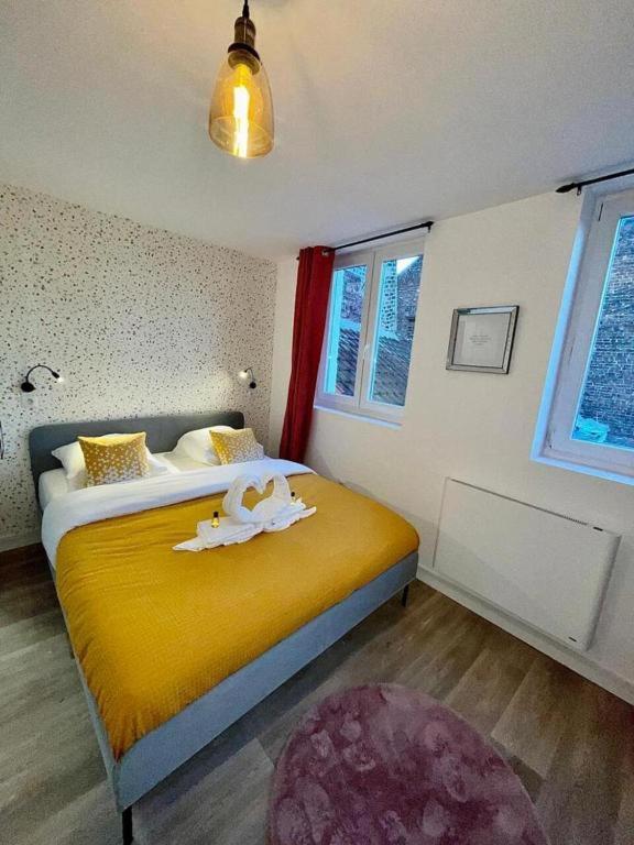 - une chambre avec un lit jaune et une couverture jaune dans l'établissement Le Big Road spots, à Roubaix