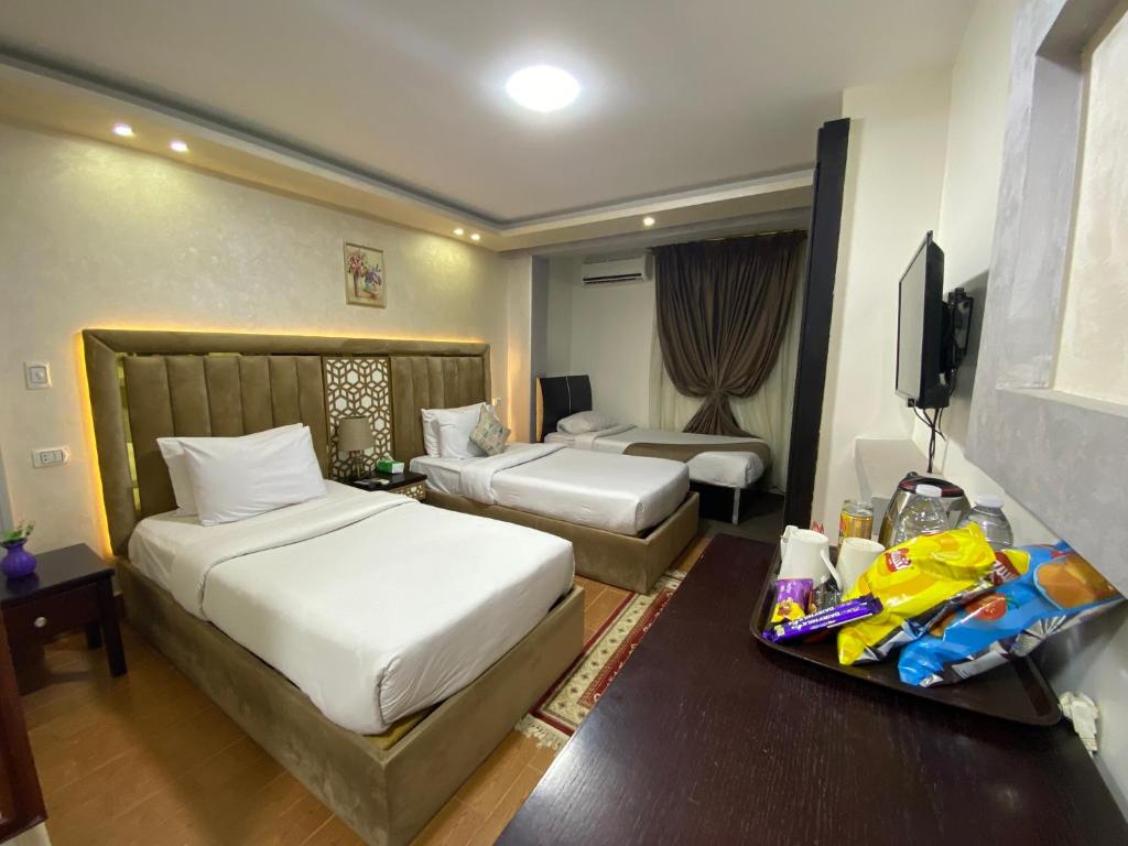 Ένα ή περισσότερα κρεβάτια σε δωμάτιο στο Golden Pyramids View Inn