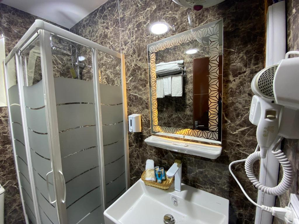 a bathroom with a sink and a mirror at Golden Pyramids View Inn in Cairo