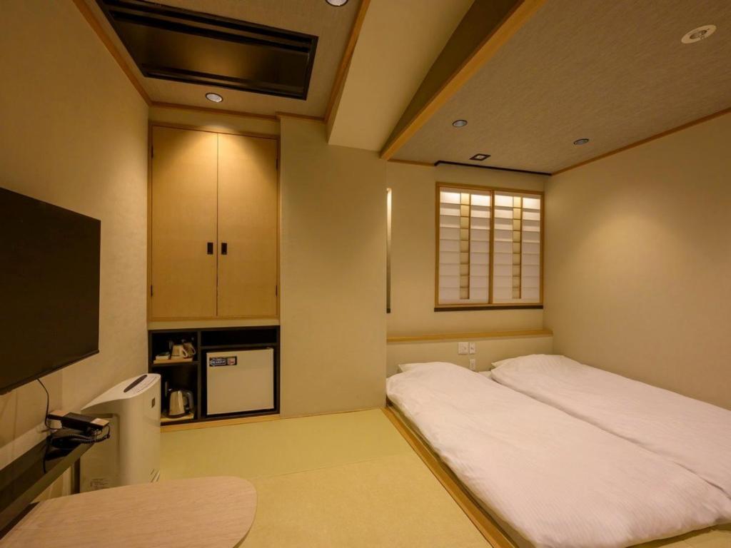 Postel nebo postele na pokoji v ubytování Hotel Isago Kobe