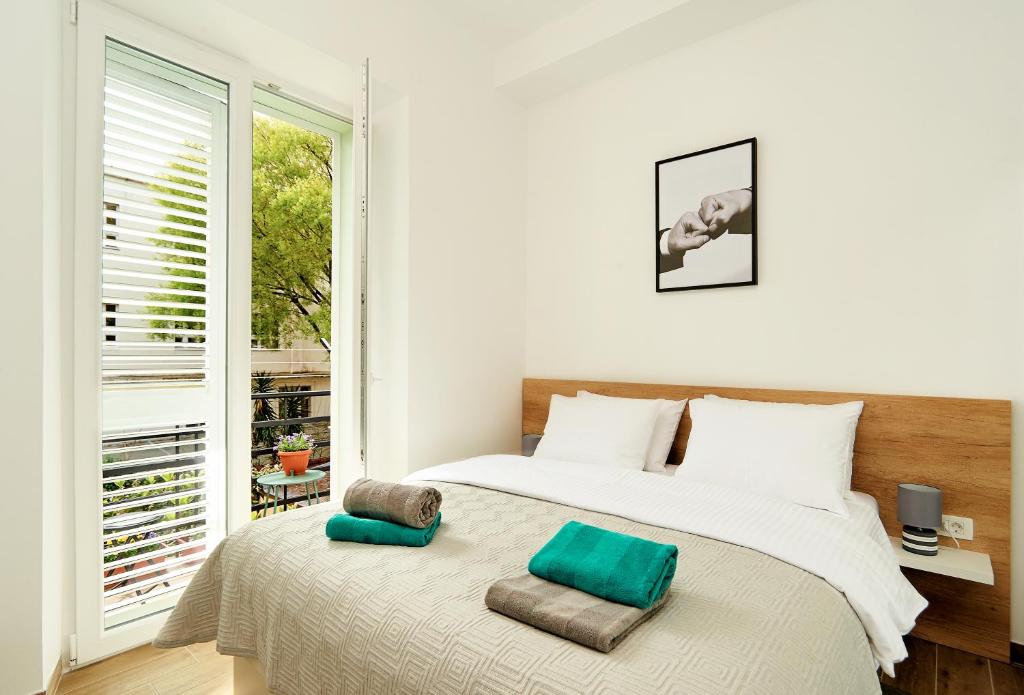 Postel nebo postele na pokoji v ubytování Regina Apartment