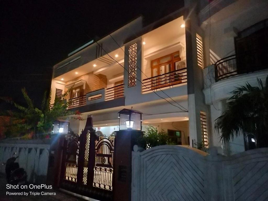 a building with a fence in front of it at night at Saraswati homestay in Ayodhya