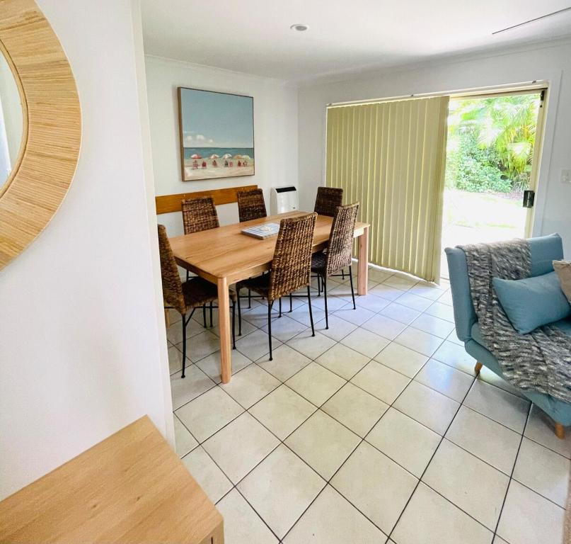 a dining room with a table and chairs at Ocean Tropics Lush Villa at Aanuka Resort in Coffs Harbour