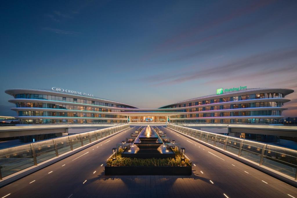 a view of a building with two buildings at Crowne Plaza Wuhan Tianhe Airport by IHG in Wuhan