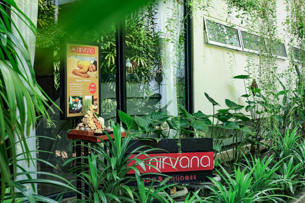 a shop with plants in front of a building at Lynnaya Urban River Resort in Siem Reap