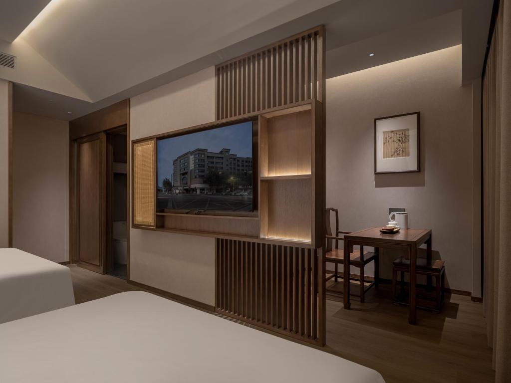 Krevet ili kreveti u jedinici u okviru objekta Chengdu Jianshantang Hotel Kuanzhai Alley Branch