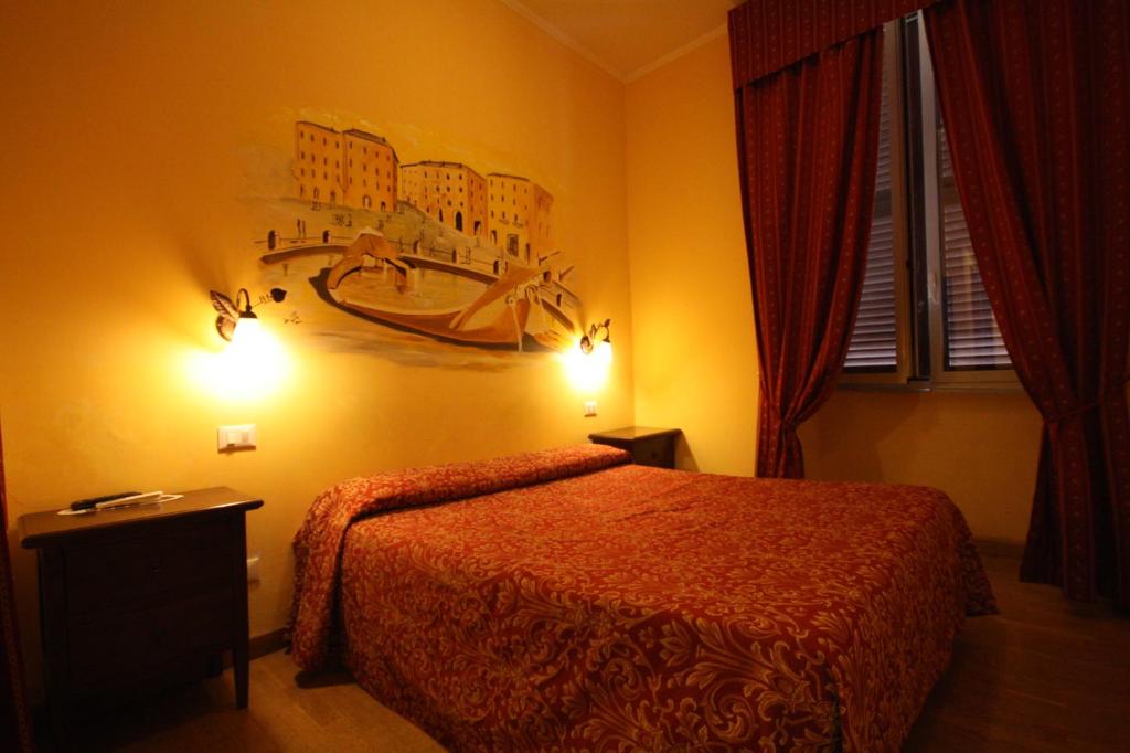 Postel nebo postele na pokoji v ubytování Hotel Cherubini