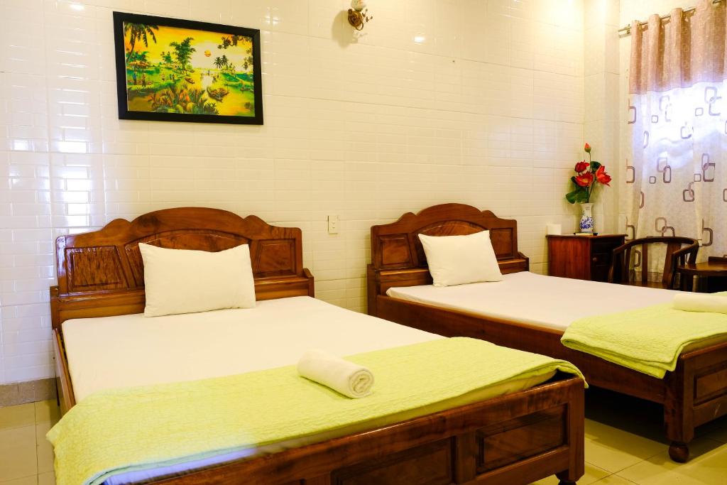 Postel nebo postele na pokoji v ubytování Lucky Hội an Hotel