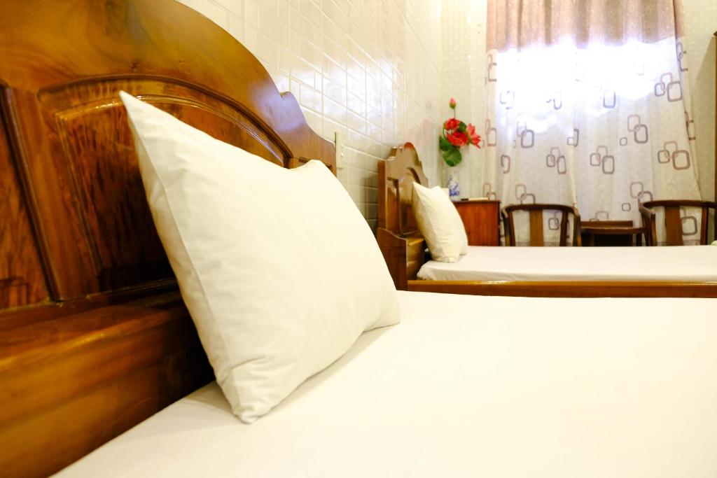 Postel nebo postele na pokoji v ubytování Lucky Hội an Hotel