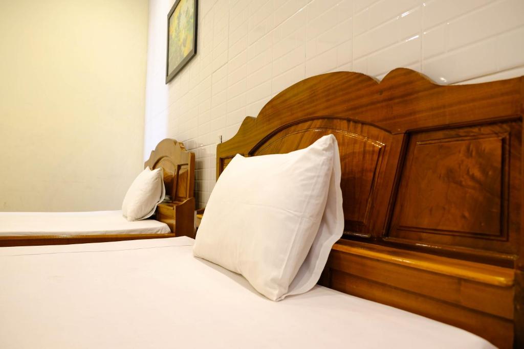 Postel nebo postele na pokoji v ubytování Lucky Hội an Hotel