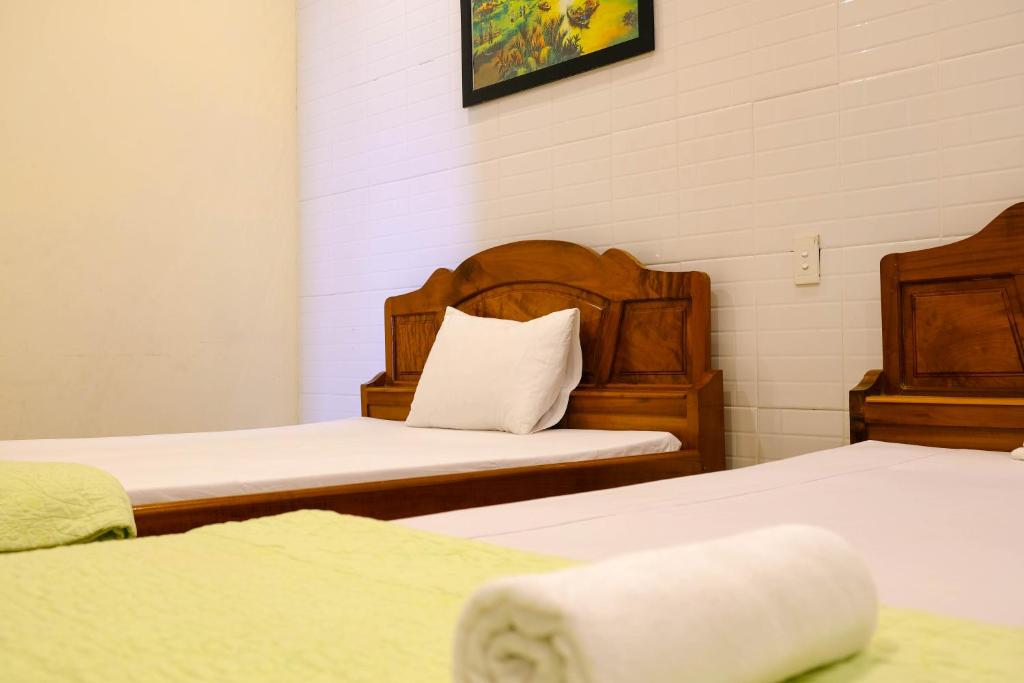 Postel nebo postele na pokoji v ubytování Lucky Hội an Hotel