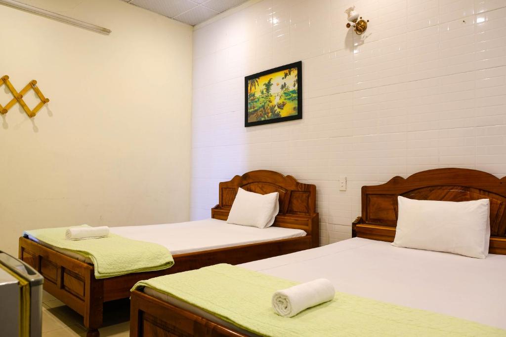 Postel nebo postele na pokoji v ubytování Lucky Hội an Hotel