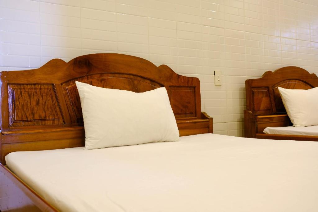 Postel nebo postele na pokoji v ubytování Lucky Hội an Hotel