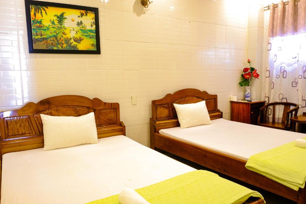 Postel nebo postele na pokoji v ubytování Lucky Hội an Hotel