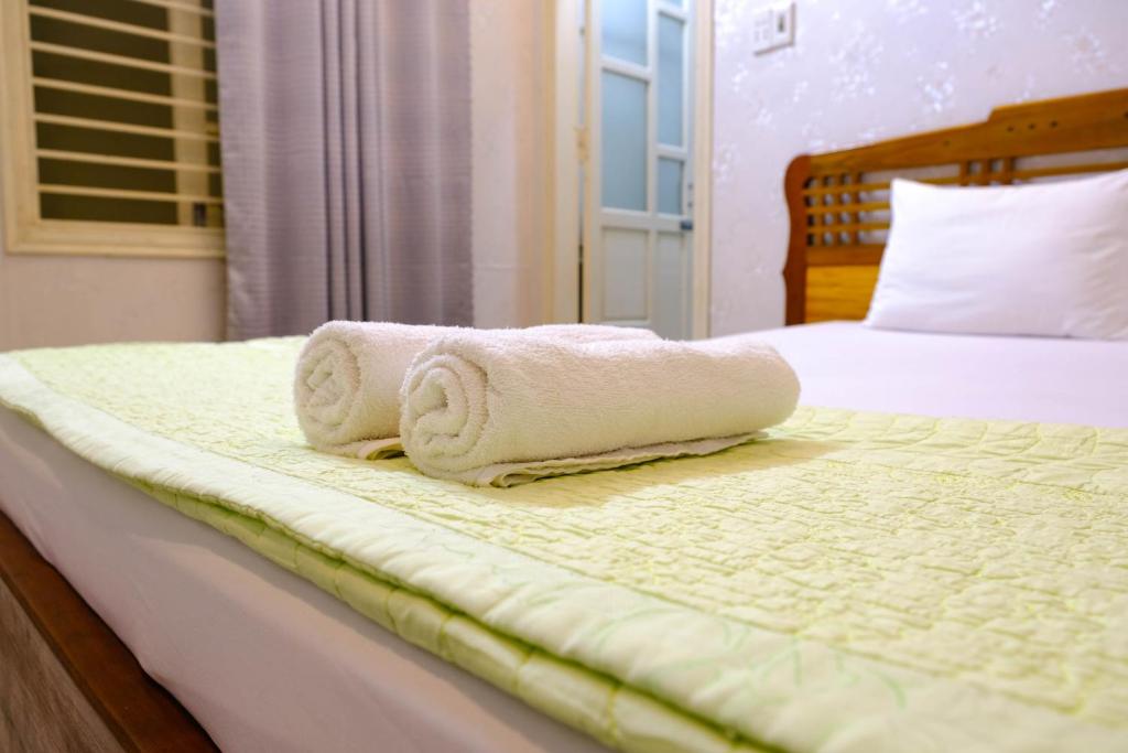 Postel nebo postele na pokoji v ubytování Lucky Hội an Hotel